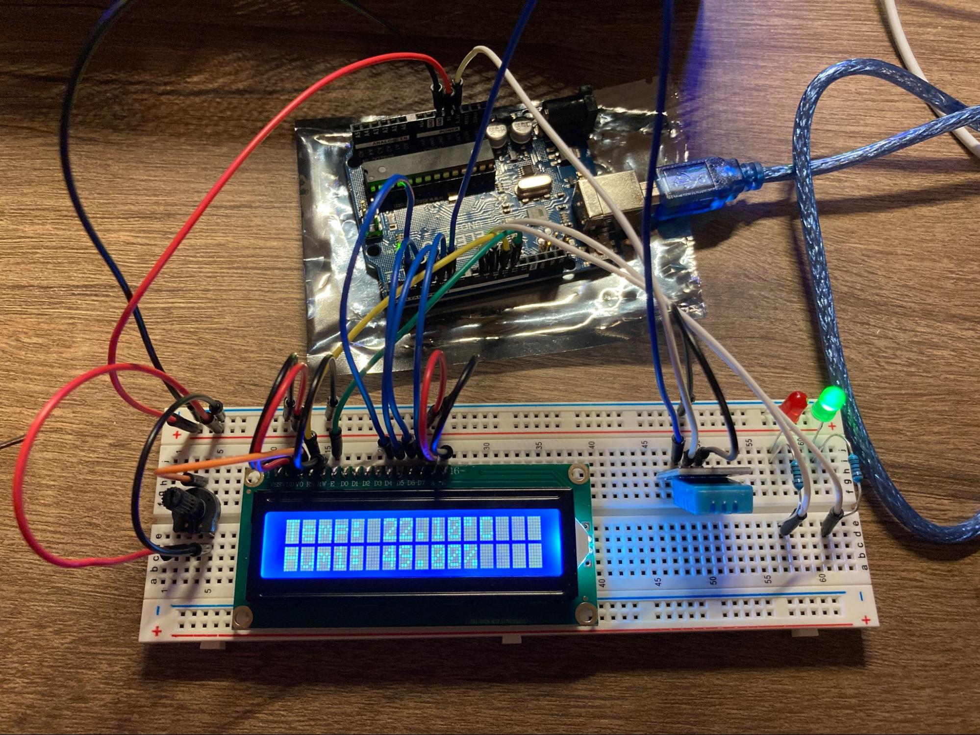 Arduino setup with a temperature and humidity sensor sending output to a display
